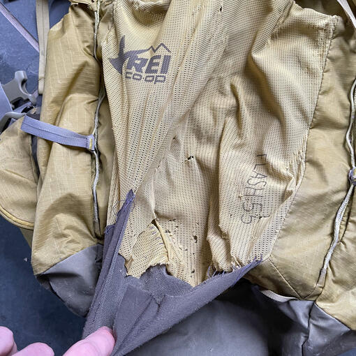 Before - Torn mesh panel on backpack.