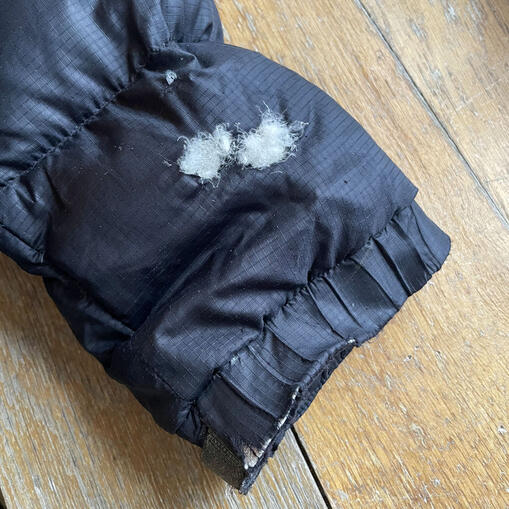 Before - burn hole in down jacket. Before - burn hole in down jacket.