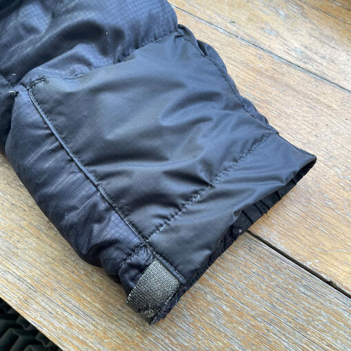 After - Sewn patch on down jacket sleeve. After - Sewn patch on down jacket sleeve.